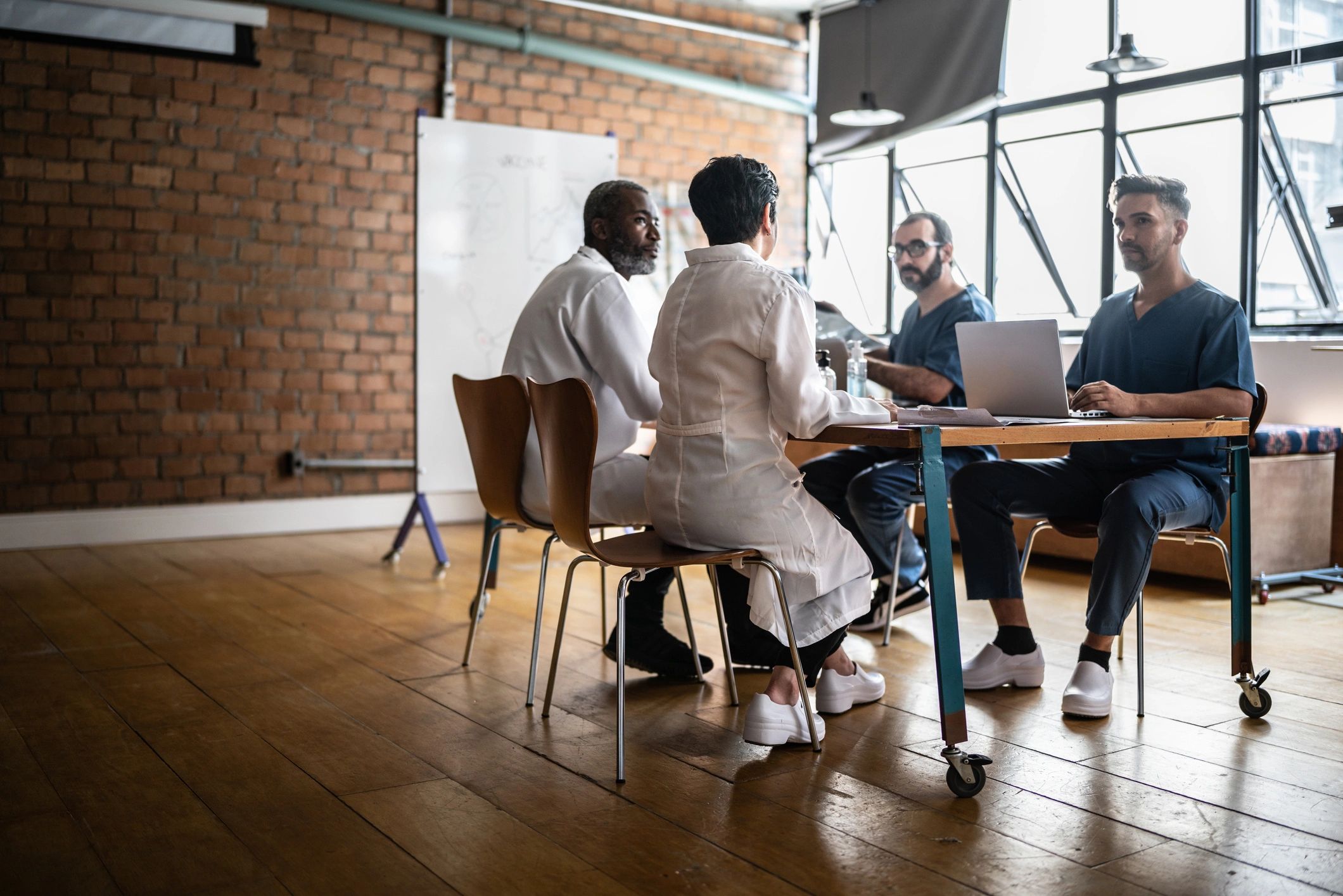 Healthcare professionals collaborating in a clinic meeting.