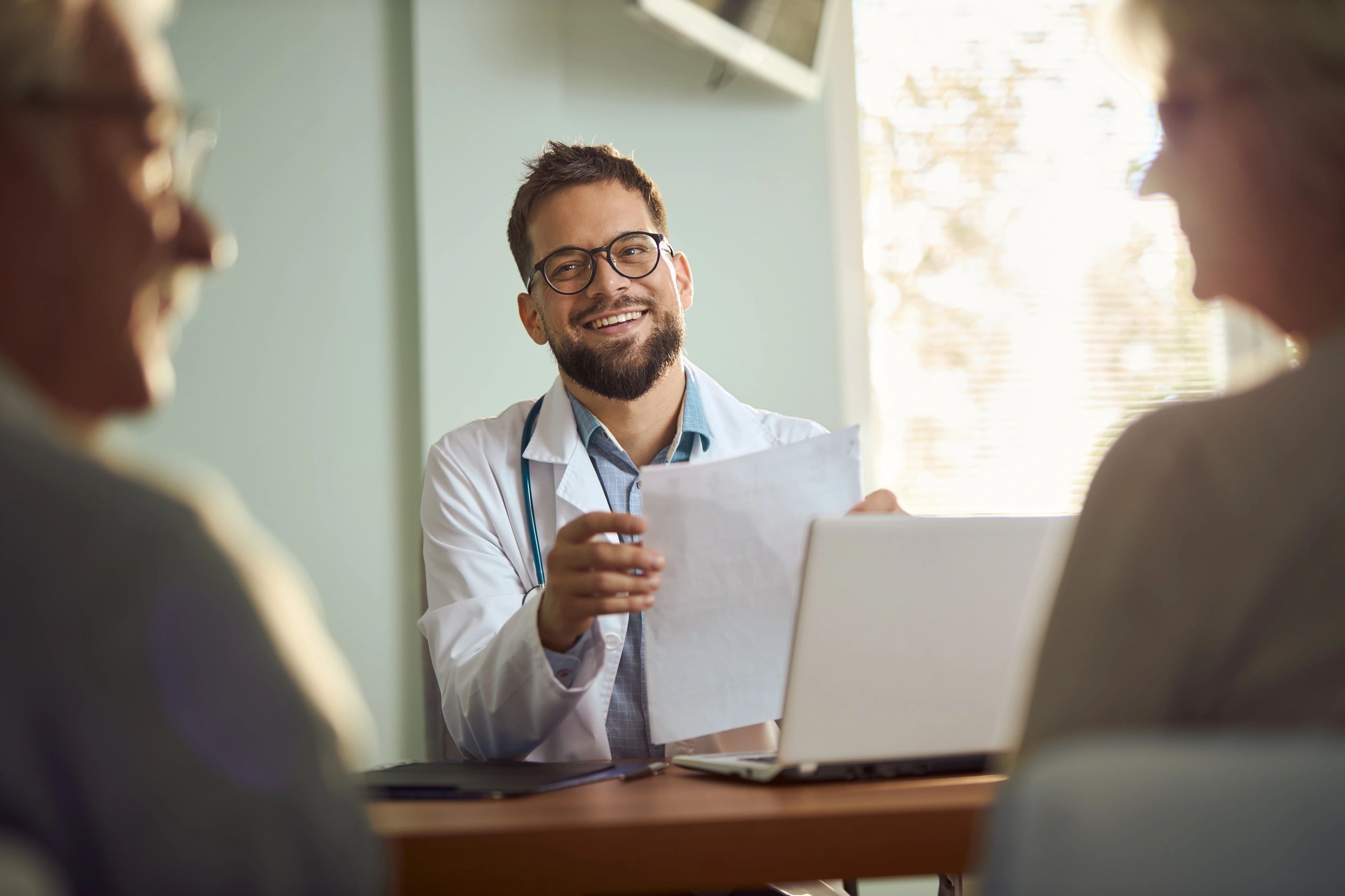 Healthcare professional speaking with patients, representing client testimonial
